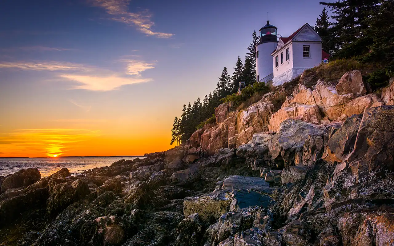 A stunning view of Acadia National Park with lush greenery, pristine lakes, and dramatic mountain landscapes.
