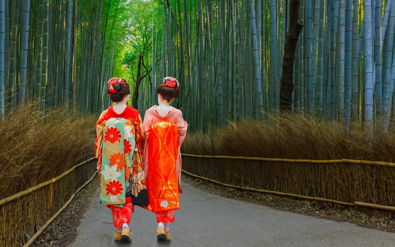 A geisha posing gracefully amidst the serene Arashiyama Bamboo Grove in Kyoto, Japan.