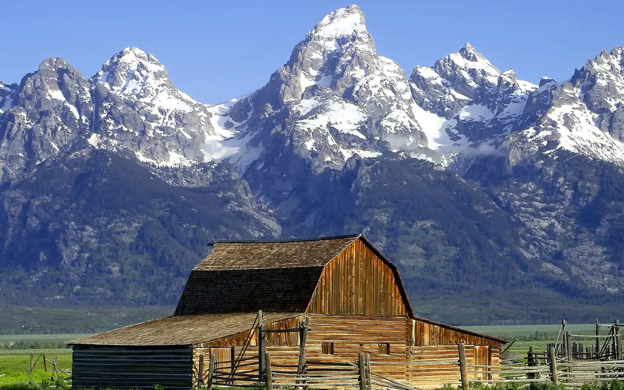 Scenic view of majestic mountain peaks and lush green landscape at Grand Teton National Park