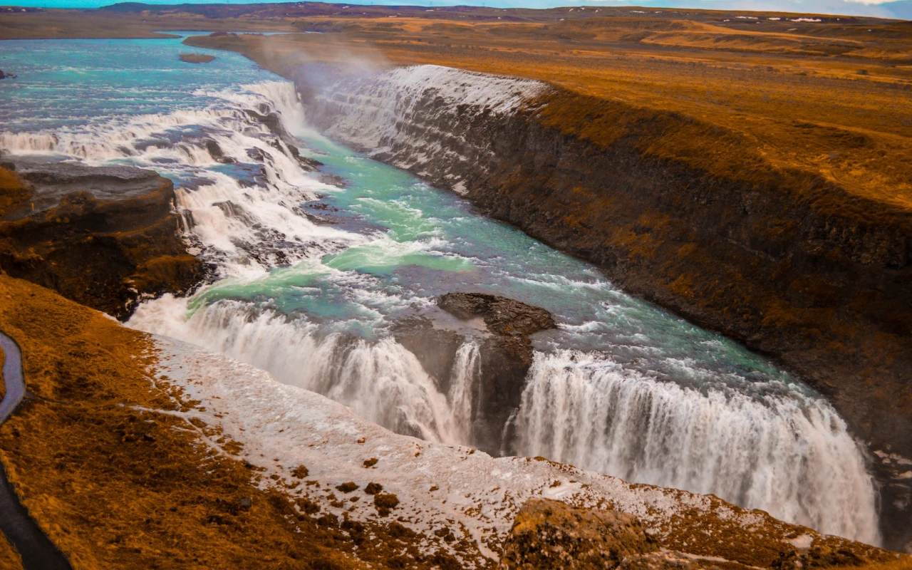 Stunning Gullfoss waterfalls in Iceland with cascading water and lush green landscape