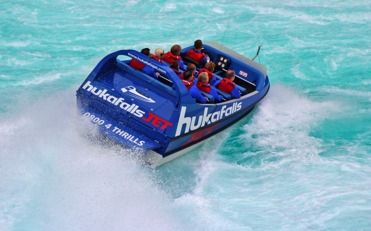 Stunning Huka Falls showcasing powerful turquoise water cascading over rocky cliffs in New Zealand