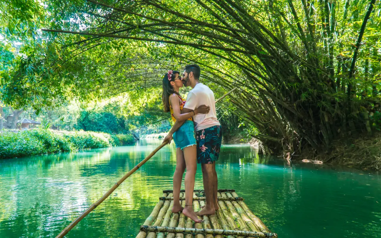 Tropical beach in Jamaica with crystal clear blue water and palm trees lining the shore