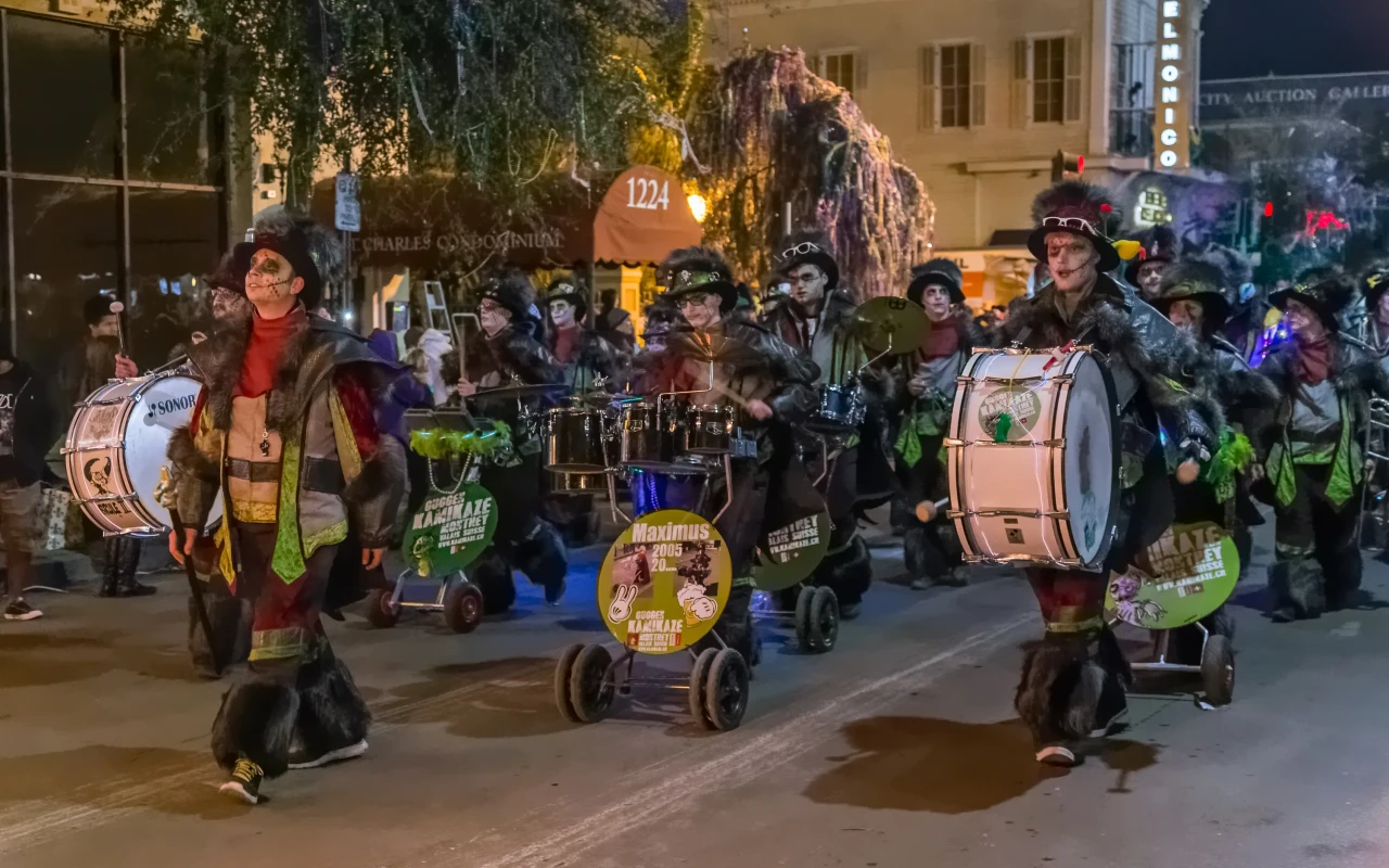 Group of people celebrating Mardi Gras in New Orleans with colorful costumes and masks