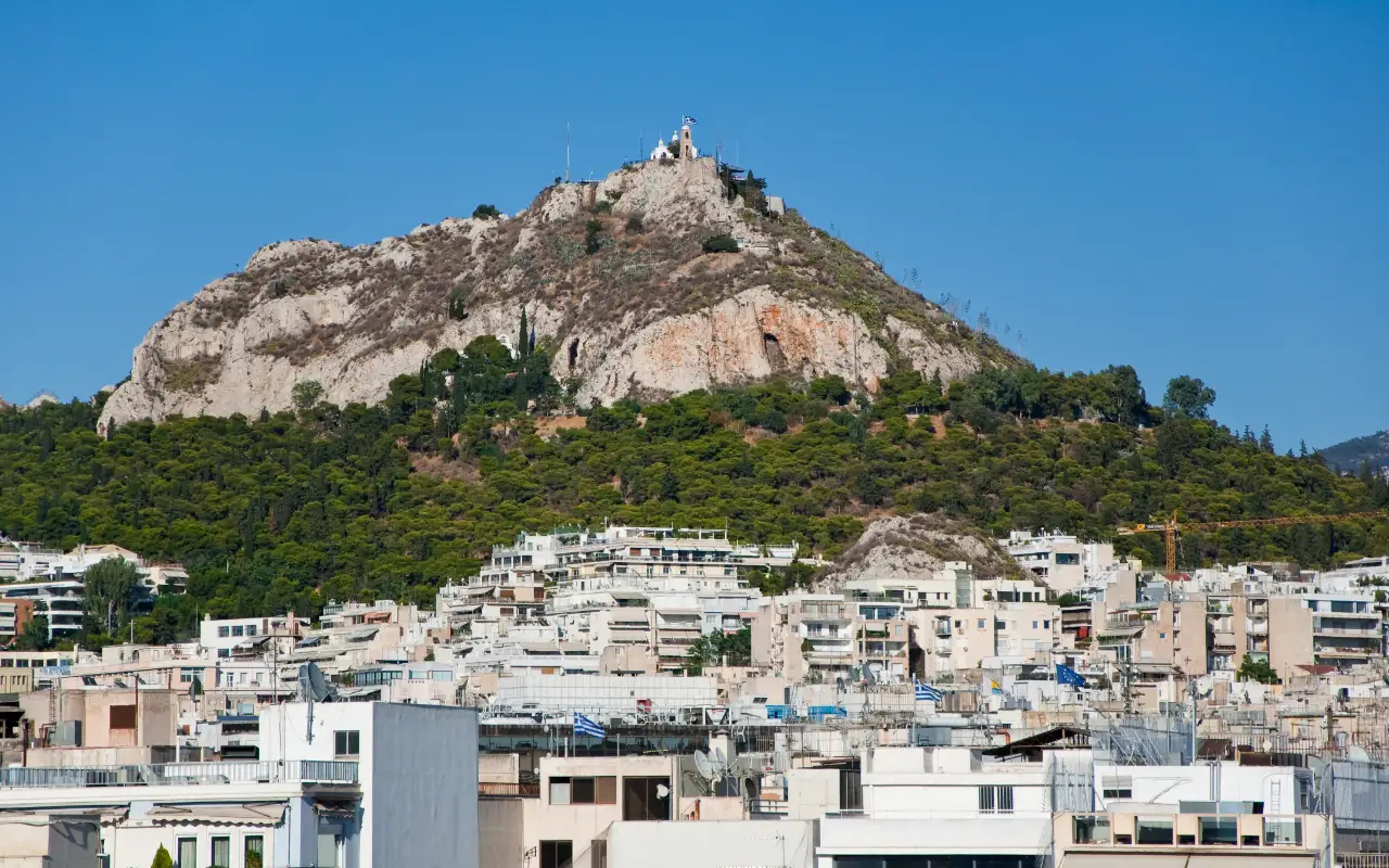 Mount Lycabettus in Athens, Greece - a hill offering panoramic views of Athens and the Aegean Sea, accessible by foot or cable car, and known for its stunning sunset vistas.