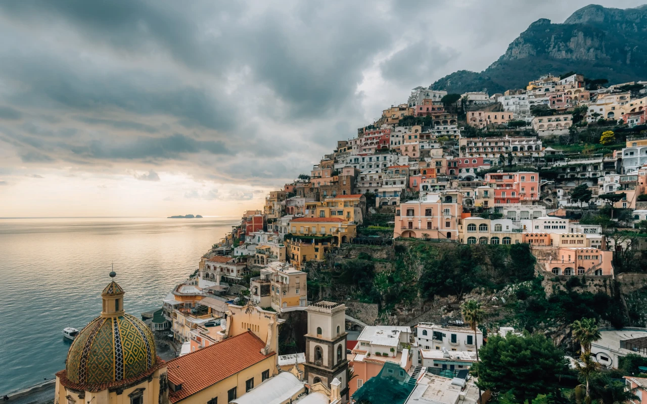Couple enjoying a romantic sunset dinner overlooking the beautiful Amalfi Coast in Italy
