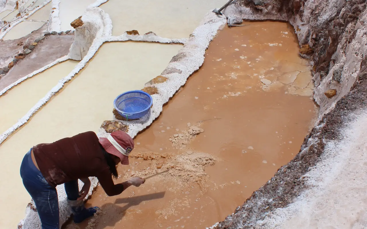 Workers harvesting salt in the Salinas de Maras salt mines, Peru.