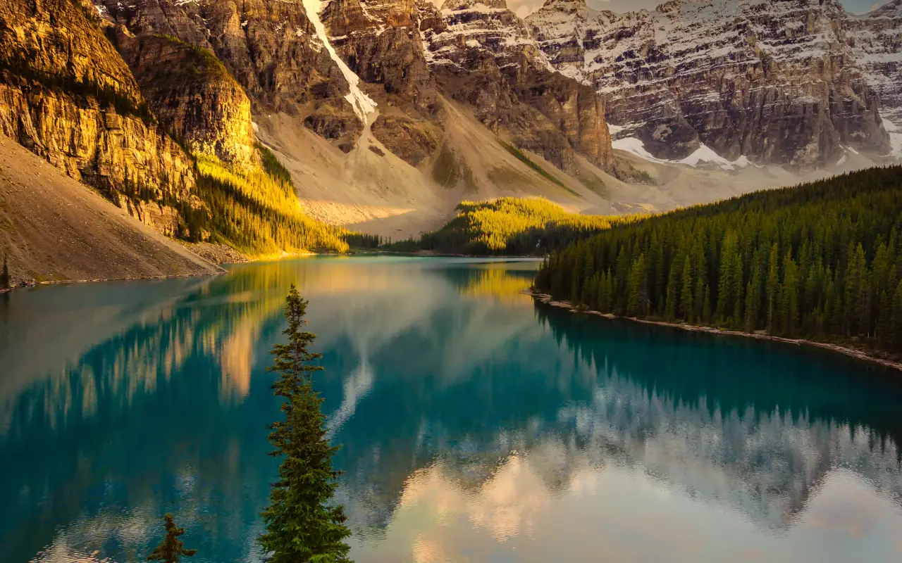 Tranquil mountain lake reflecting sunset colors