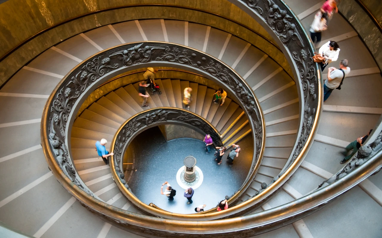 Interior view of the Vatican Museums featuring various historical artifacts and paintings