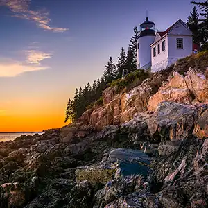 A stunning view of Acadia National Park with lush greenery, pristine lakes, and dramatic mountain landscapes.