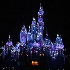 Group of happy kids and families enjoying a fun-filled day at Disneyland Park with iconic rides and attractions in the background