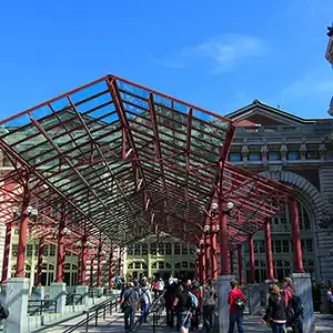A historic photo of immigrants arriving at Ellis Island, the gateway to America for millions of people during the early 20th century