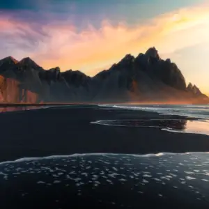 Scenic view of mountains and beach in Iceland at sunset