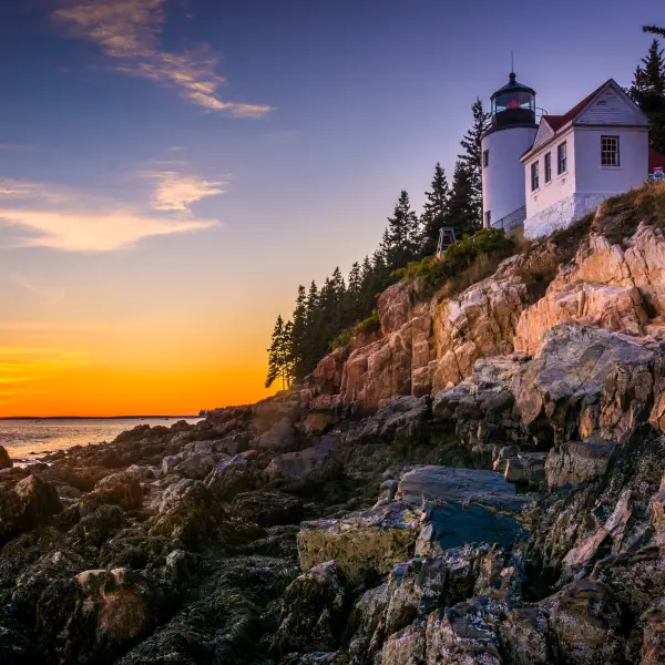 A stunning view of Acadia National Park with lush greenery, pristine lakes, and dramatic mountain landscapes.