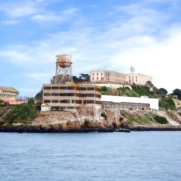 Scenic view of the historic Alcatraz Island with surrounding waters and cloudy sky