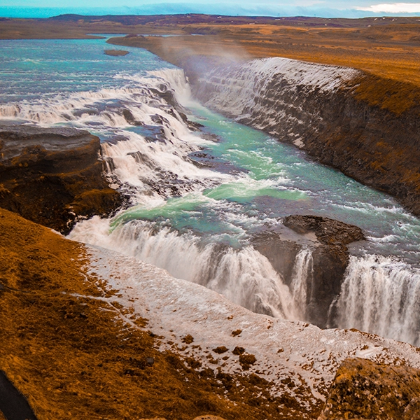 Stunning Gullfoss waterfalls in Iceland with cascading water and lush green landscape