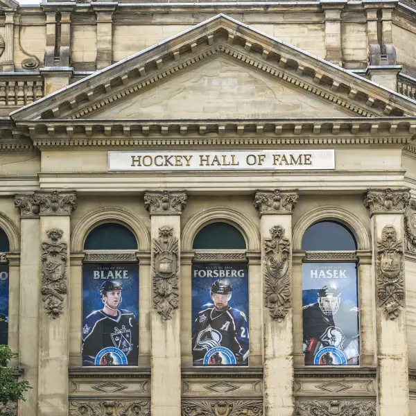 Hockey Hall of Fame entrance with famous players' statues and museum exhibits in the background