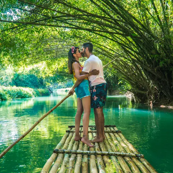 Tropical beach in Jamaica with crystal clear blue water and palm trees lining the shore
