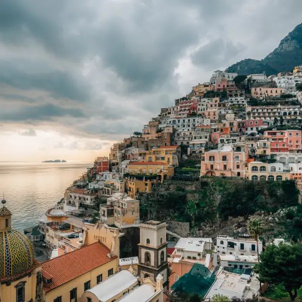 Couple enjoying a romantic sunset dinner overlooking the beautiful Amalfi Coast in Italy